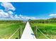 White dock leading to a covered boat lift on a calm waterway at 16147 Lankford Ct, Port Charlotte, FL 33981