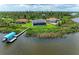 Aerial view of a waterfront home with a private dock and boat at 16147 Lankford Ct, Port Charlotte, FL 33981