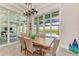 Bright dining room with wooden table and chairs, and water views at 16147 Lankford Ct, Port Charlotte, FL 33981