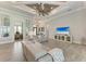 Open living area with gray sofas, wood-look floors, and views into other rooms at 16147 Lankford Ct, Port Charlotte, FL 33981