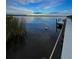 Evening view of a white dock on a calm body of water at 16147 Lankford Ct, Port Charlotte, FL 33981