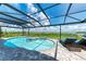 Inviting pool and lanai with water views and comfortable lounge chairs at 16147 Lankford Ct, Port Charlotte, FL 33981