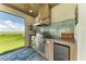 Luxury outdoor kitchen with stainless steel appliances and a waterfront view at 16147 Lankford Ct, Port Charlotte, FL 33981