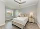 Cozy bedroom with ceiling fan, and grey wood flooring at 16147 Lankford Ct, Port Charlotte, FL 33981
