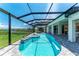 Relaxing pool area with covered lanai, spa, and access to the home at 16147 Lankford Ct, Port Charlotte, FL 33981