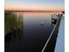 Peaceful sunset view over calm water from a dock at 16147 Lankford Ct, Port Charlotte, FL 33981