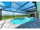 Resort-style pool with covered lanai, spa, and outdoor kitchen; water view at 16147 Lankford Ct, Port Charlotte, FL 33981