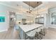 Bright kitchen with white cabinets, large island with seating, and stainless steel appliances at 16147 Lankford Ct, Port Charlotte, FL 33981