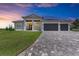 Two-story home with a three-car garage and landscaped lawn at 16147 Lankford Ct, Port Charlotte, FL 33981