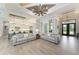 Open living space showcasing a kitchen and entryway, with gray sofas and a wood-look floor at 16147 Lankford Ct, Port Charlotte, FL 33981