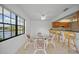 Bright dining area with lake view and glass table at 23465 Harborview Rd # 1021, Punta Gorda, FL 33980