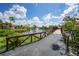Picturesque bridge over a pond with a fountain, showcasing a tranquil community at 23465 Harborview Rd # 1021, Punta Gorda, FL 33980