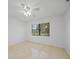 Bright bedroom with tile floor and ceiling fan at 23465 Harborview Rd # 1021, Punta Gorda, FL 33980