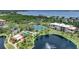 Aerial view of community with lake, tennis courts, and pool at 23465 Harborview Rd # 1021, Punta Gorda, FL 33980