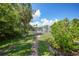 Brick walkway next to pond with lush tropical landscaping at 23465 Harborview Rd # 1021, Punta Gorda, FL 33980