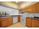 Kitchen with wood cabinets, granite counters and appliances at 23465 Harborview Rd # 1021, Punta Gorda, FL 33980
