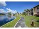 Paved pathway beside a lake in a residential community at 23465 Harborview Rd # 1021, Punta Gorda, FL 33980