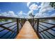 Wooden footbridge spanning a pond, offering scenic views of the community at 23465 Harborview Rd # 1021, Punta Gorda, FL 33980