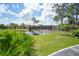 Wooden footbridge over a pond in a lush, green community at 23465 Harborview Rd # 1021, Punta Gorda, FL 33980