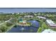 Aerial view of community with lake, tennis courts, and pool at 23465 Harborview Rd # 1021, Punta Gorda, FL 33980