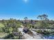 Gated entrance to community with guardhouse and lush landscaping at 23465 Harborview Rd # 1021, Punta Gorda, FL 33980