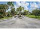 Landscaped entrance to community with palm trees and lush greenery at 23465 Harborview Rd # 1021, Punta Gorda, FL 33980
