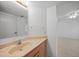 Light beige bathroom vanity with wood cabinets and a sink at 23465 Harborview Rd # 1021, Punta Gorda, FL 33980