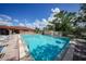 Inviting community pool with lounge chairs and surrounding landscaping at 23465 Harborview Rd # 1021, Punta Gorda, FL 33980