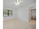 Bedroom with tile floor, ceiling fan and bathroom access at 23465 Harborview Rd # 1021, Punta Gorda, FL 33980