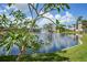 Community pond with fountain and bridge reflecting buildings at 23465 Harborview Rd # 1021, Punta Gorda, FL 33980