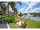 Relaxing pond-side seating area with benches and fountain view at 23465 Harborview Rd # 1021, Punta Gorda, FL 33980