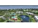 Aerial view of community with lake, tennis courts, and pool at 23465 Harborview Rd # 1021, Punta Gorda, FL 33980