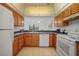 Kitchen with wood cabinets, granite counters and appliances at 23465 Harborview Rd # 1021, Punta Gorda, FL 33980