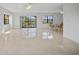 Spacious living room with tile floors and access to balcony at 23465 Harborview Rd # 1021, Punta Gorda, FL 33980