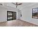Bright bedroom with wood-look tile floors, sliding glass doors to lanai, and pool view at 8356 Tecumseh Cir, Port Charlotte, FL 33981