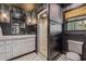 Modern bathroom with a glass shower and dark-wood accents at 13310 Anglers Way, Placida, FL 33946