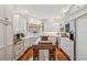 Modern kitchen with white cabinets, island, and hardwood floors at 13310 Anglers Way, Placida, FL 33946