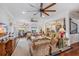 Bright living room with hardwood floors, comfortable seating, and access to a balcony at 13310 Anglers Way, Placida, FL 33946