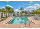 Community pool with ample seating and surrounding landscaping at 13310 Anglers Way, Placida, FL 33946