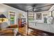 Main bedroom with water views, a king-size bed, and hardwood floors at 13310 Anglers Way, Placida, FL 33946