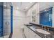 Modern bathroom with blue tile and granite countertops at 13310 Anglers Way, Placida, FL 33946