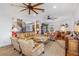 Spacious living room with ample seating, hardwood floors, and a spiral staircase at 13310 Anglers Way, Placida, FL 33946