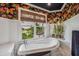Bathroom with freestanding bathtub and window overlooking the street at 13310 Anglers Way, Placida, FL 33946