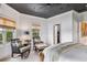 Comfortable bedroom with sitting area and access to bathroom at 13310 Anglers Way, Placida, FL 33946