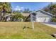 Charming single-story home featuring a well-manicured lawn and beautiful tropical landscaping at 4322 Concert St, Port Charlotte, FL 33948