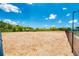 Dog park with wood chip surface and shaded seating at 3255 Village Ln, Port Charlotte, FL 33953