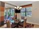 Bright dining room with glass table and wicker chairs, looking out to a tranquil backyard at 27453 Hole In One Pl, Englewood, FL 34223