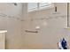 Walk-in shower with tile surround and grab bar at 27453 Hole In One Pl, Englewood, FL 34223