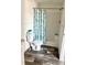 Bathroom with shower, toilet, and wood-look floor at 1377 Ibis Dr, Englewood, FL 34224