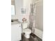 Bathroom with tub, toilet, and patterned shower curtain at 1377 Ibis Dr, Englewood, FL 34224